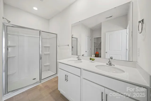 a bathroom with a shower sink and mirror
