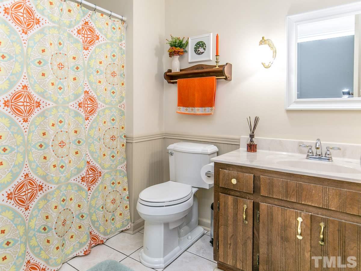 4025 Iverson Street Raleigh, NC 27604 - Photo 14 of 24 a bathroom with a sink toilet and shower