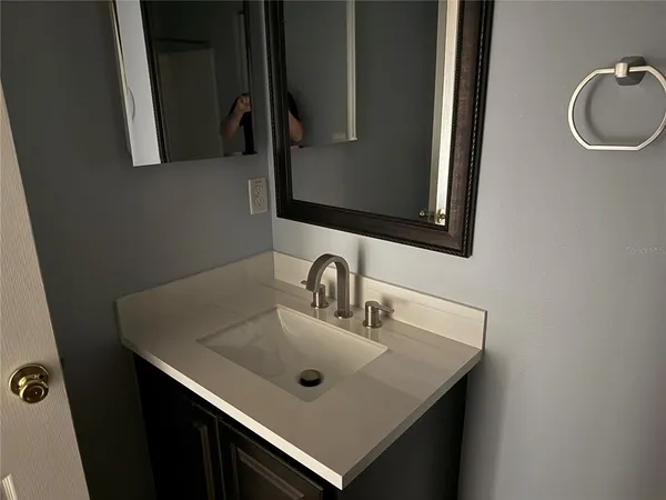 a bathroom with a sink and a mirror