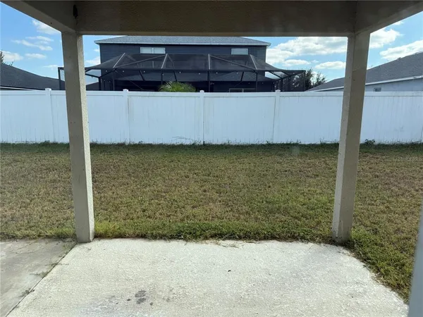 a view of a room with a wooden fence