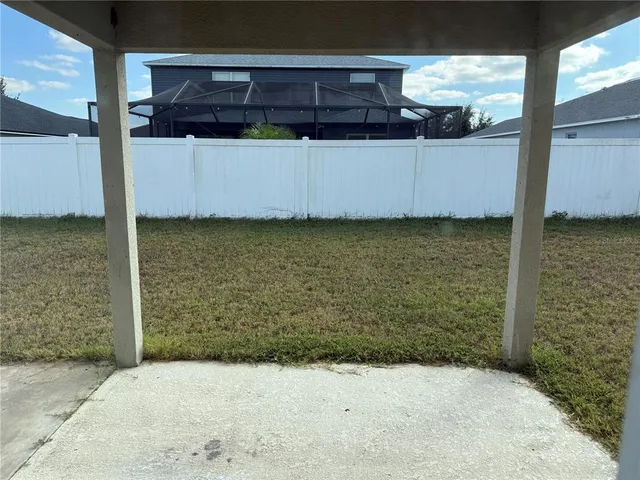a view of a room with a wooden fence