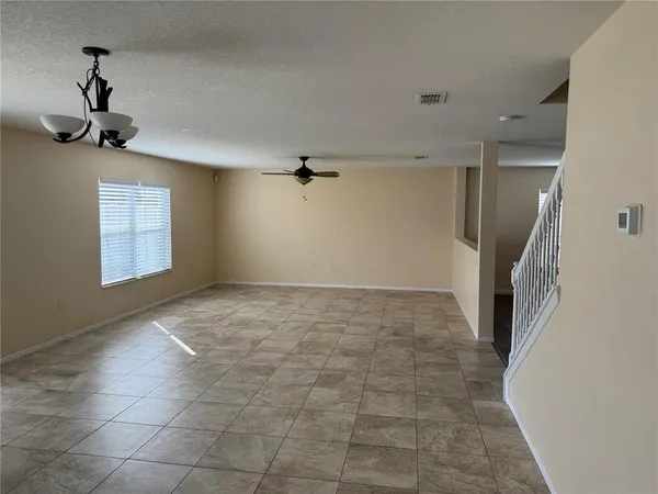 a view of a livingroom with a ceiling fan and window
