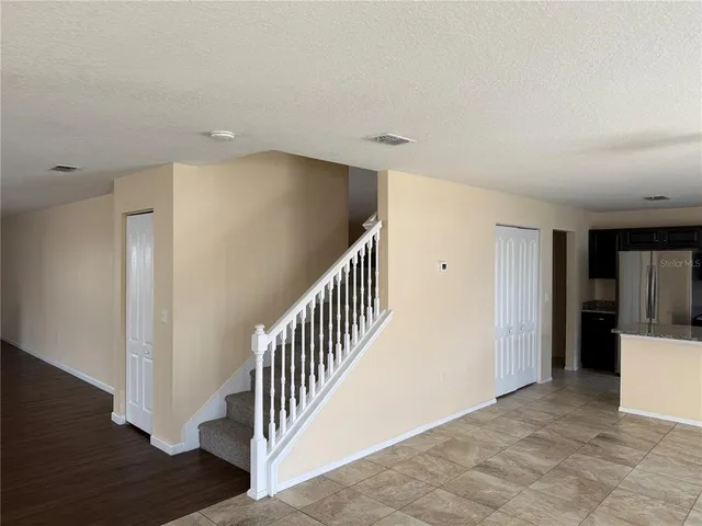 a view of a hallway with wooden floor and entryway