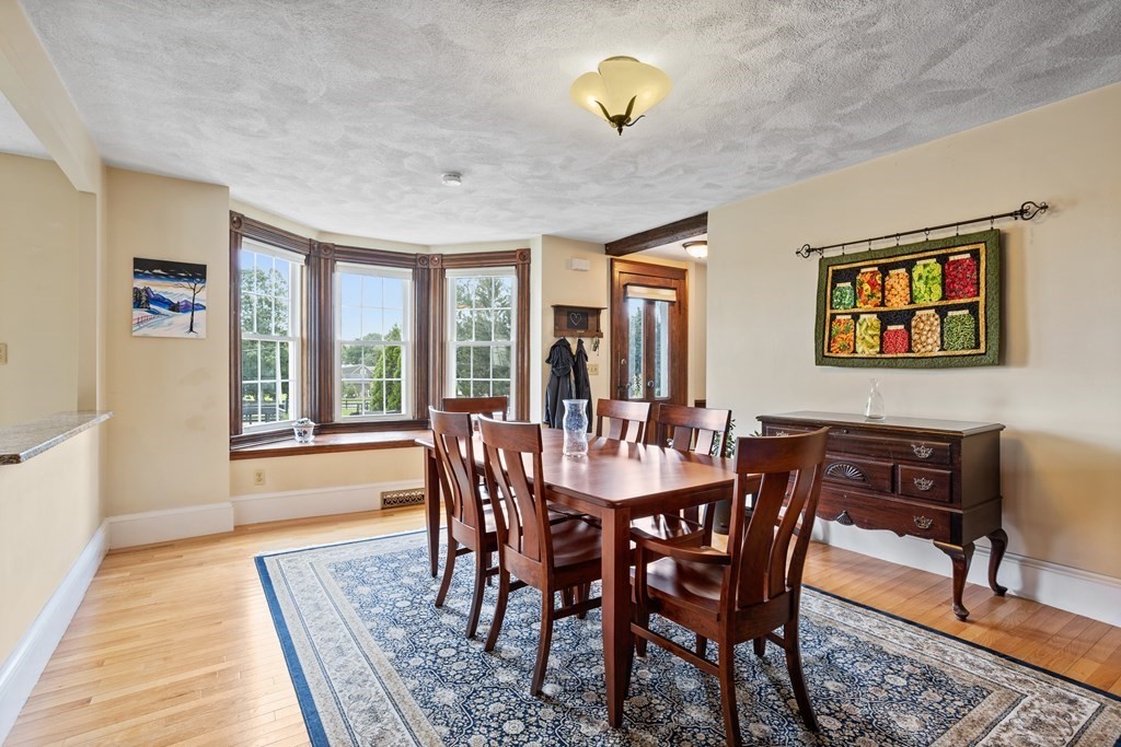 120 Goldsmith Street, Unit 3 Littleton, MA 01460 - Photo 13 of 33 a view of a dining room with furniture a rug and wooden floor