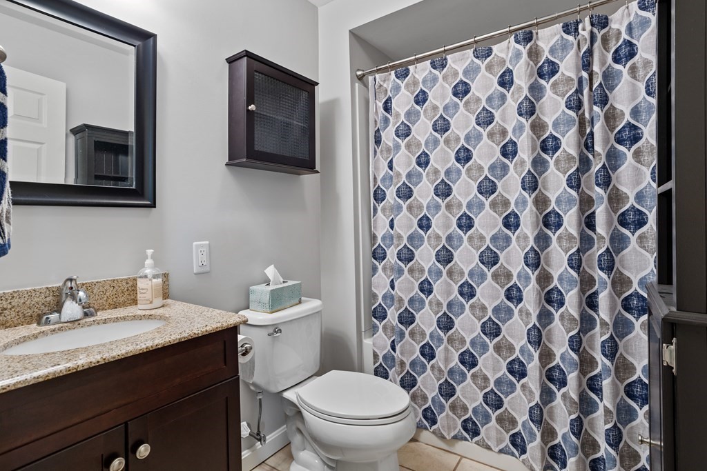 120 Goldsmith Street, Unit 3 Littleton, MA 01460 - Photo 17 of 33 a bathroom with a granite countertop sink and a toilet