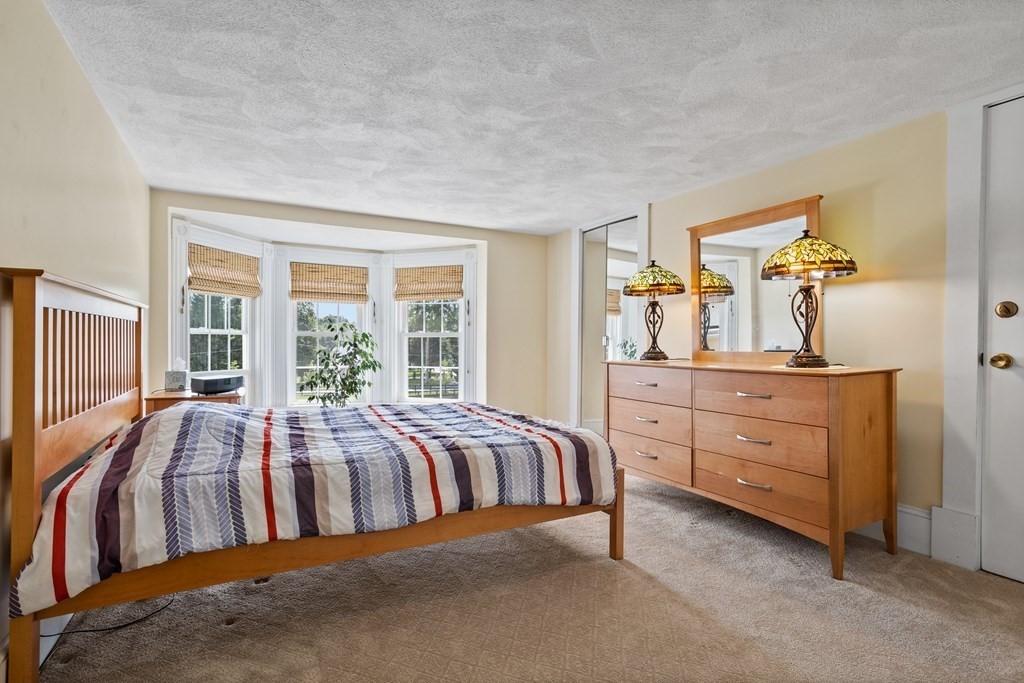 120 Goldsmith Street, Unit 3 Littleton, MA 01460 - Photo 18 of 33 a bed room with a bed and a dresser