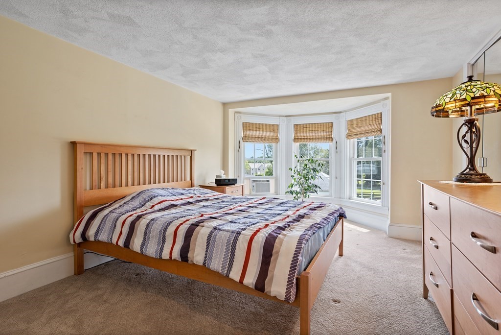 120 Goldsmith Street, Unit 3 Littleton, MA 01460 - Photo 19 of 33 a bedroom with a bed and a dresser