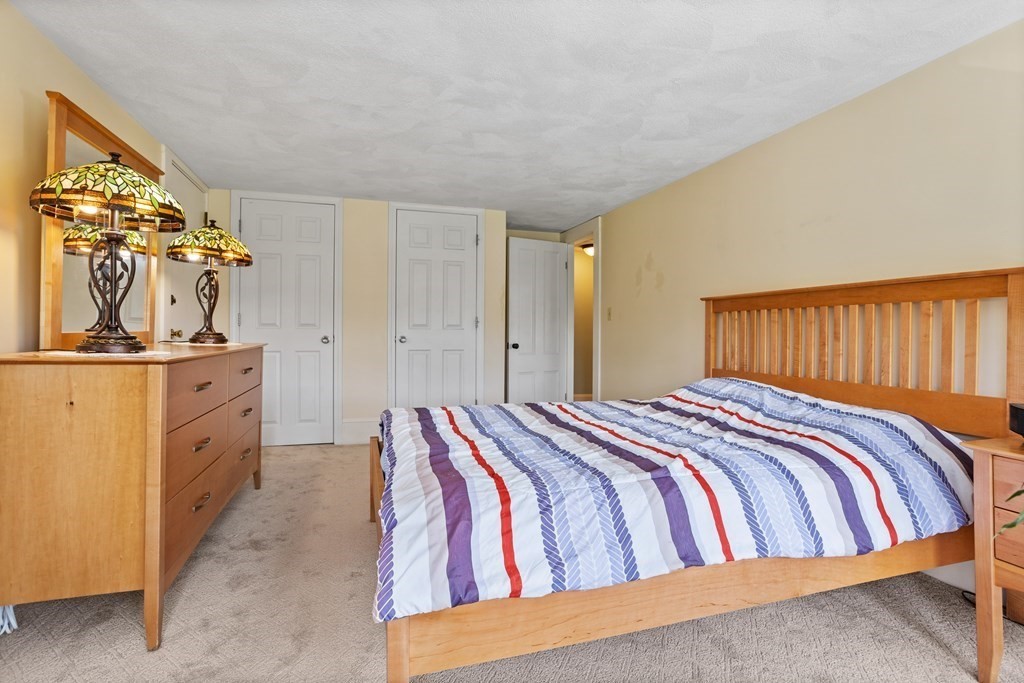 120 Goldsmith Street, Unit 3 Littleton, MA 01460 - Photo 20 of 33 a bedroom with a bed and cabinets