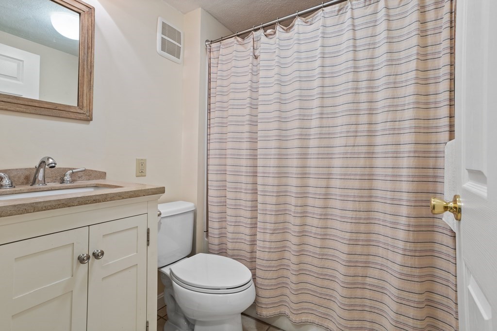 120 Goldsmith Street, Unit 3 Littleton, MA 01460 - Photo 23 of 33 a bathroom with a granite countertop toilet and sink