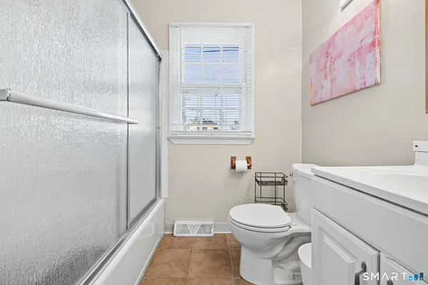 a bathroom with a toilet a sink and a shower