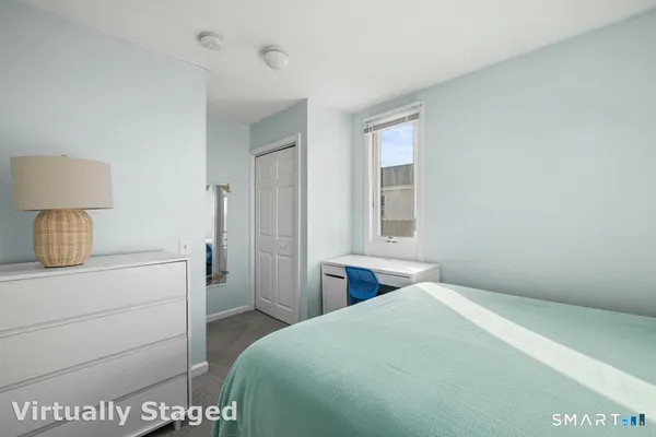 a bedroom with a bed and a window