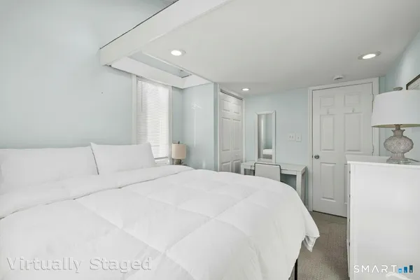 a large white bed in a white room