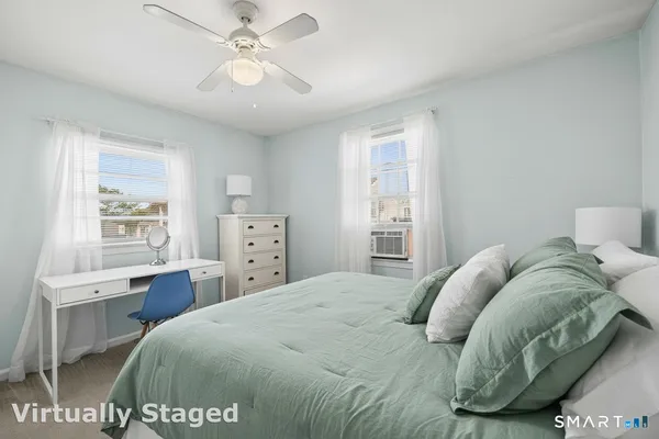 a bedroom with a bed and a window