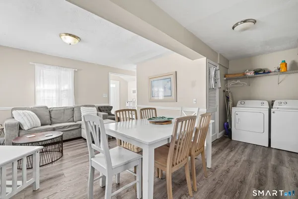 a view of a dining room with furniture and wooden floor
