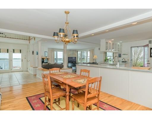 2 Quay Road Ipswich, MA 01938 - Photo 8 of 26 a dining room with wooden floor a chandelier a wooden table and chairs