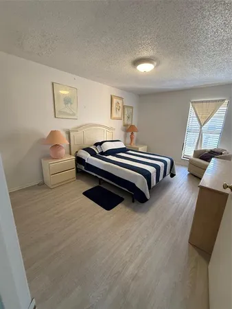 a spacious bedroom with a bed and window