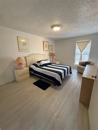 a spacious bedroom with a bed and a couch