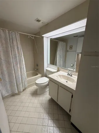 a view of bathroom with a sink and mirror