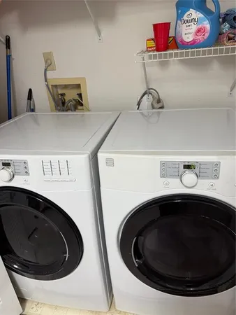 a utility room with a sink washer and dryer