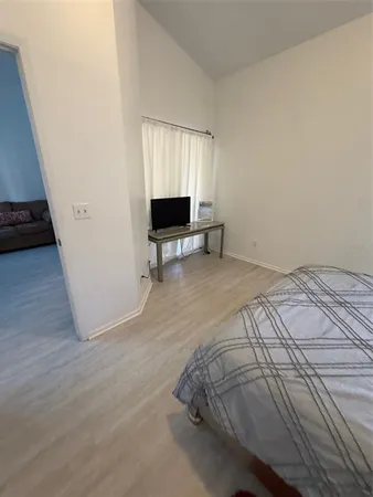 a bedroom with a bed and a television