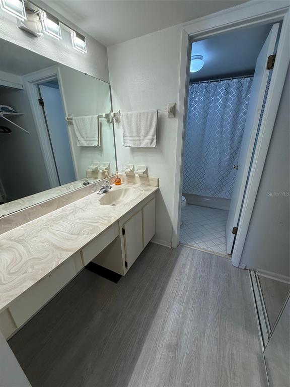 6206 Raintree Drive, Unit GE Orlando, FL 32822 - Photo 10 of 18 a bathroom with a double vanity sink and mirror