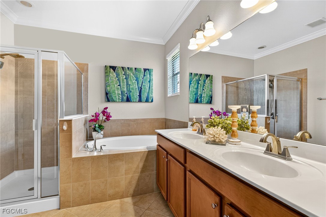 2727 Via Piazza Loop Fort Myers, FL 33905 - Photo 17 of 35 a bathroom with a tub sink and mirror