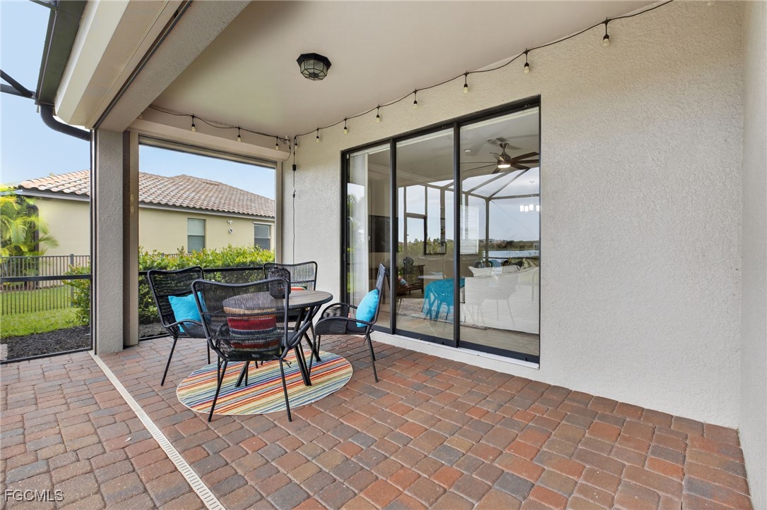 2727 Via Piazza Loop Fort Myers, FL 33905 - Photo 31 of 35 a dining room with furniture and a floor to ceiling window