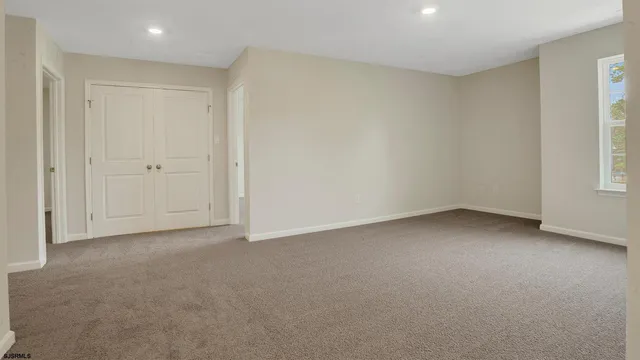 a view of an empty room and a window