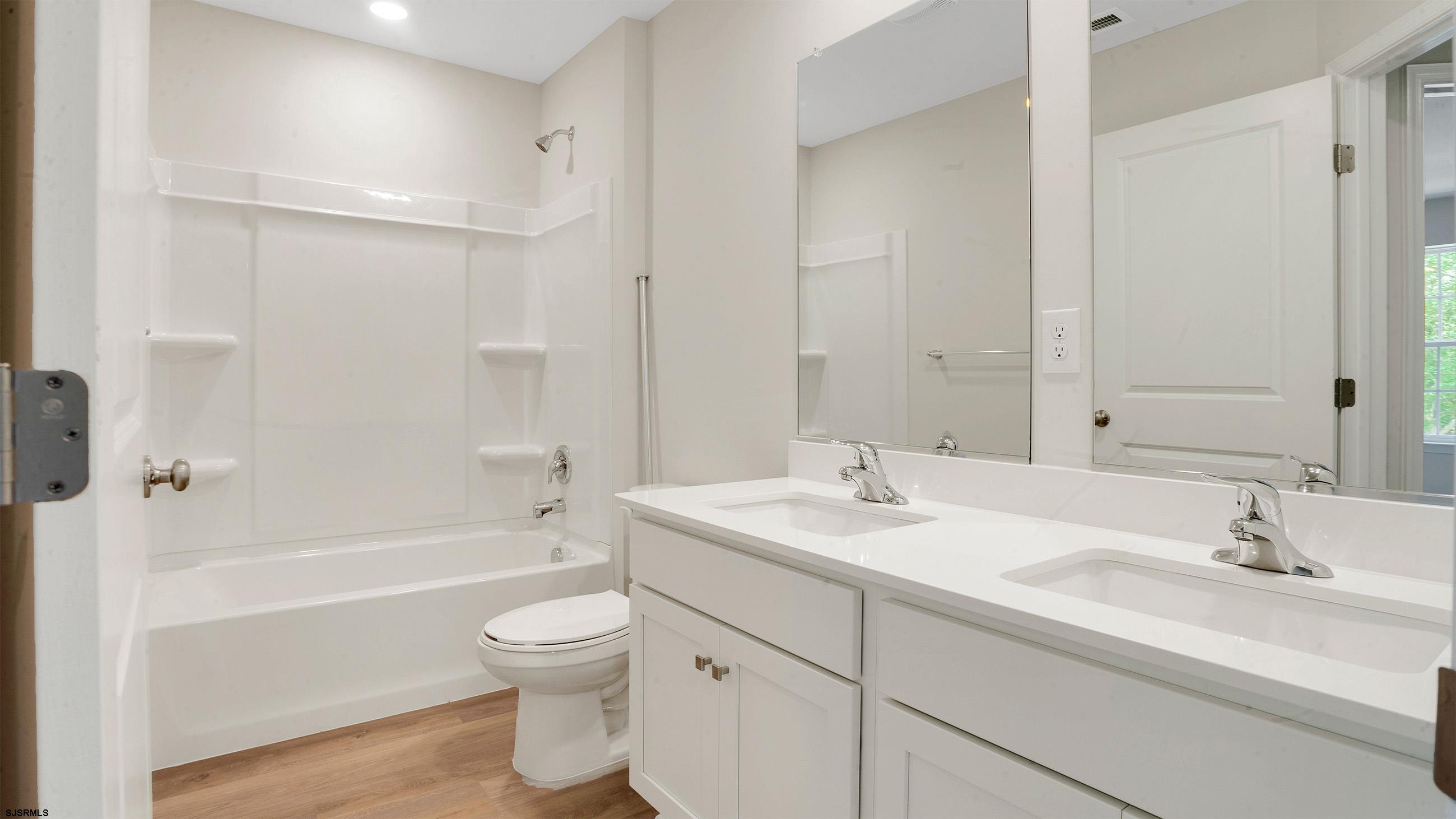 7 Emilie Court Richland, NJ 08350 - Photo 16 of 23 a bathroom with a sink a toilet and a large mirror