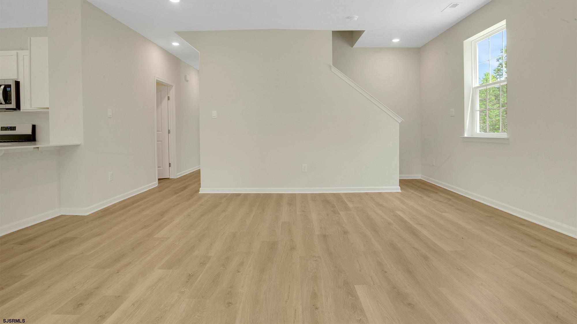 7 Emilie Court Richland, NJ 08350 - Photo 3 of 23 an empty room with wooden floor and windows