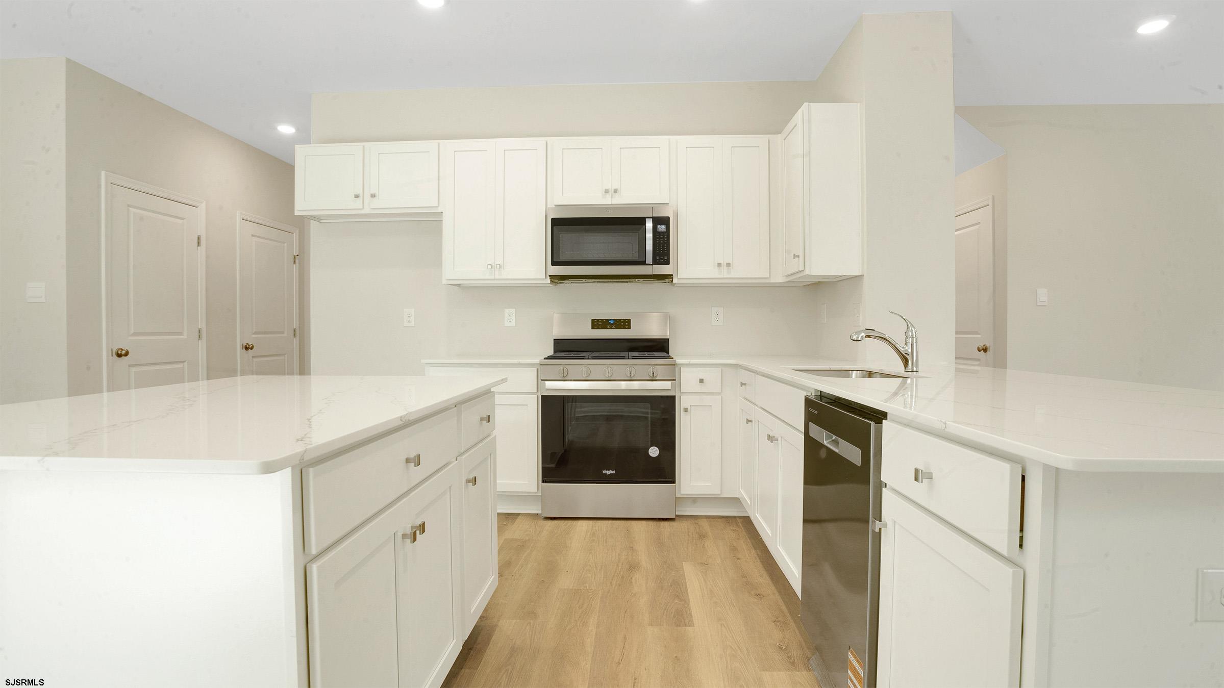 7 Emilie Court Richland, NJ 08350 - Photo 6 of 23 a kitchen with granite countertop white cabinets and stainless steel appliances