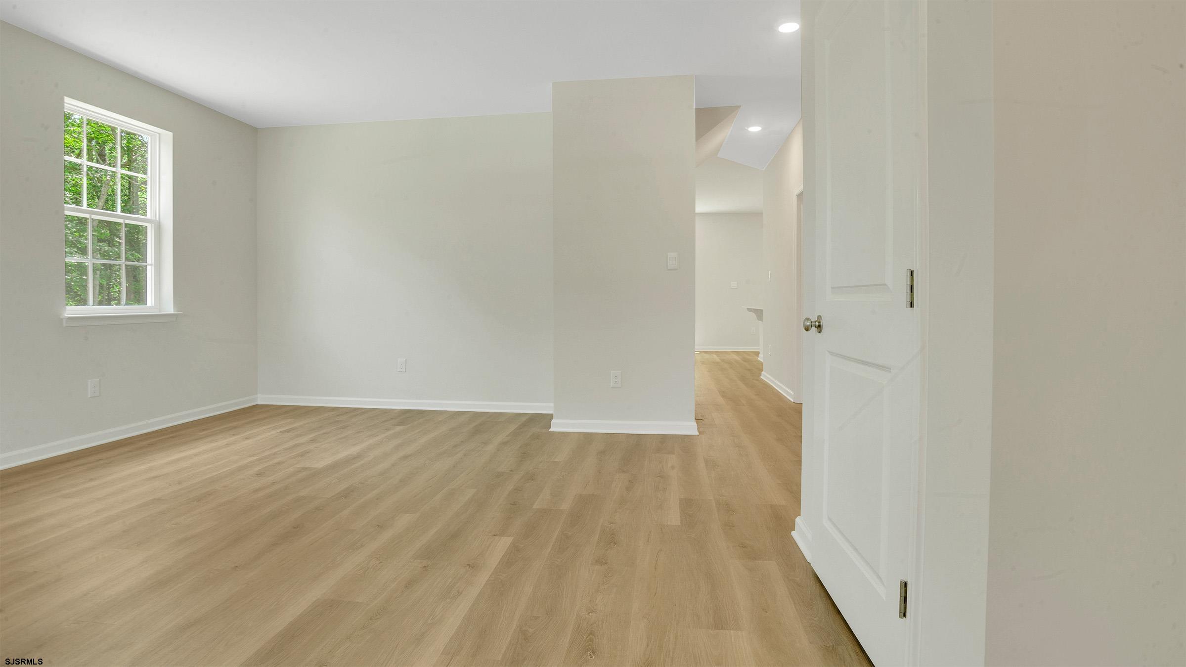 7 Emilie Court Richland, NJ 08350 - Photo 10 of 23 an empty room with wooden floor and windows