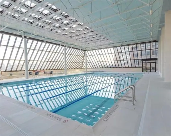 a view of swimming pool with seating space and deck
