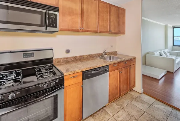 a kitchen with granite countertop a stove and a sink