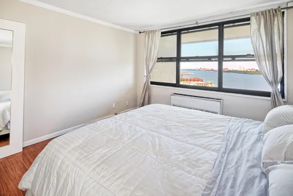 a bedroom with a large bed and a large window