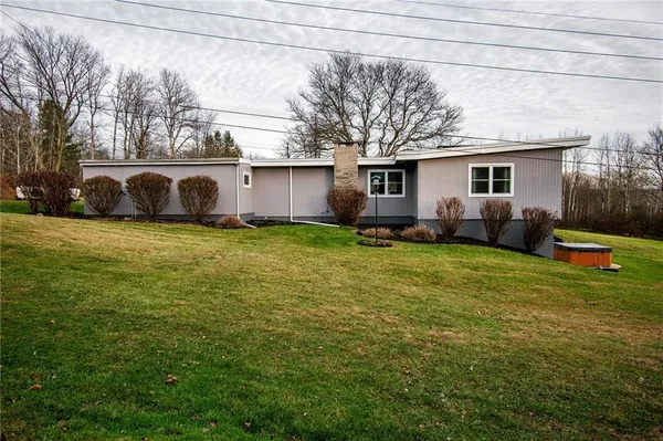 a view of a house with backyard and sitting area