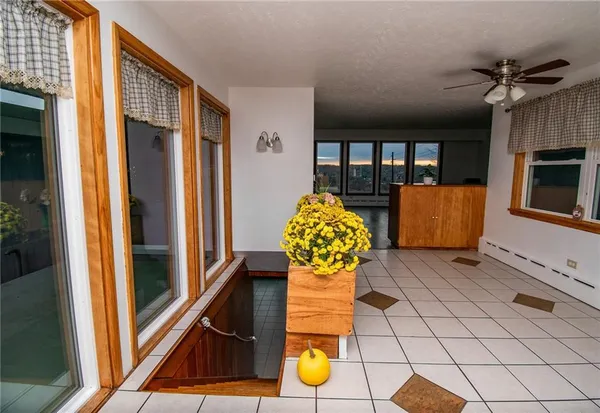 a view of a room with wooden floor and lounge chair