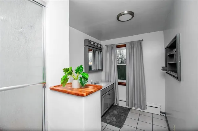 a bathroom with a granite countertop toilet sink and mirror