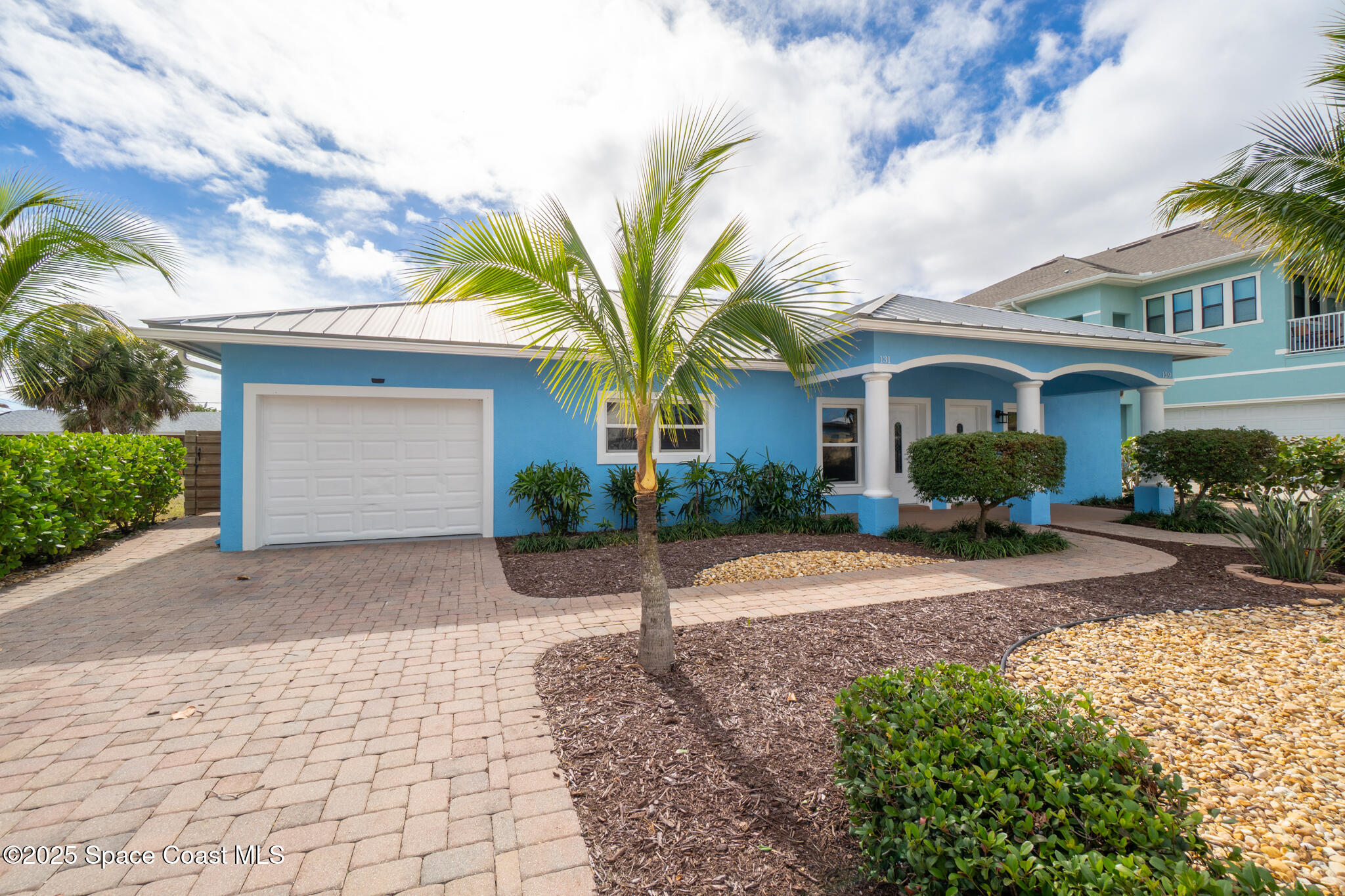 131 Harding Avenue, Unit 131 & 129 Cocoa Beach, FL 32931 - Photo 13 of 47 a front view of a house with garden