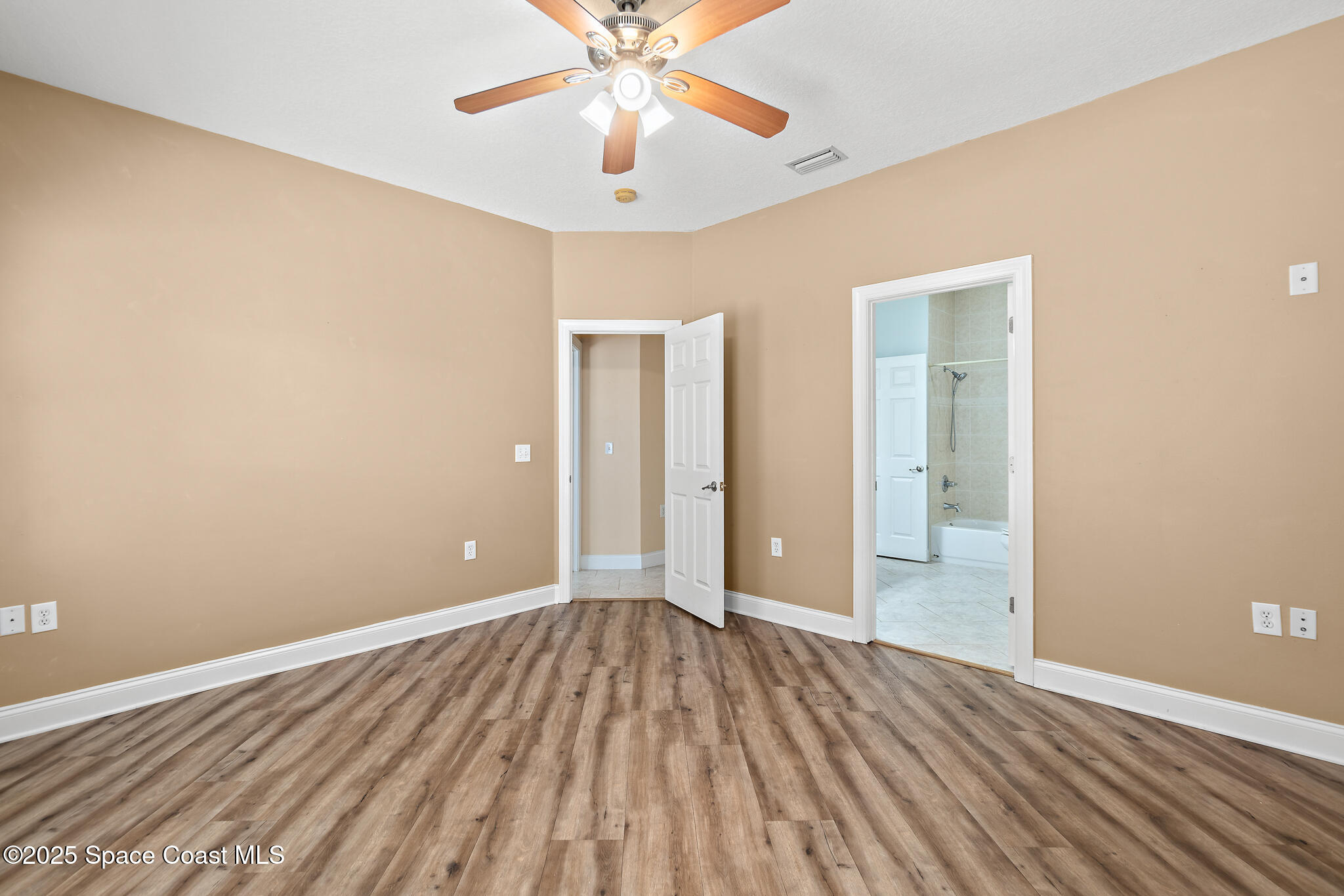 131 Harding Avenue, Unit 131 & 129 Cocoa Beach, FL 32931 - Photo 16 of 47 a view of an empty room and wooden floor
