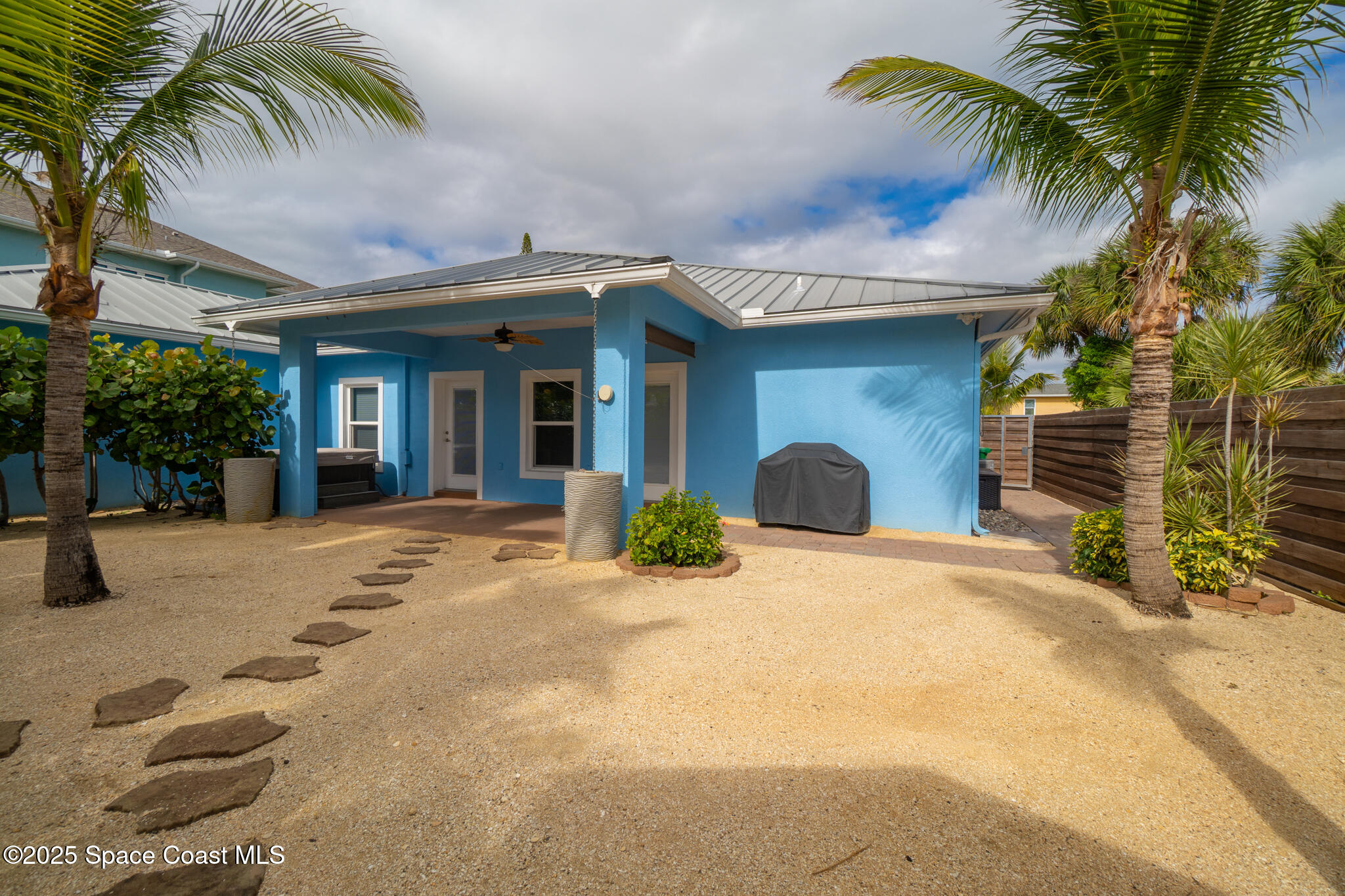 131 Harding Avenue, Unit 131 & 129 Cocoa Beach, FL 32931 - Photo 17 of 47 a view of a house with a patio