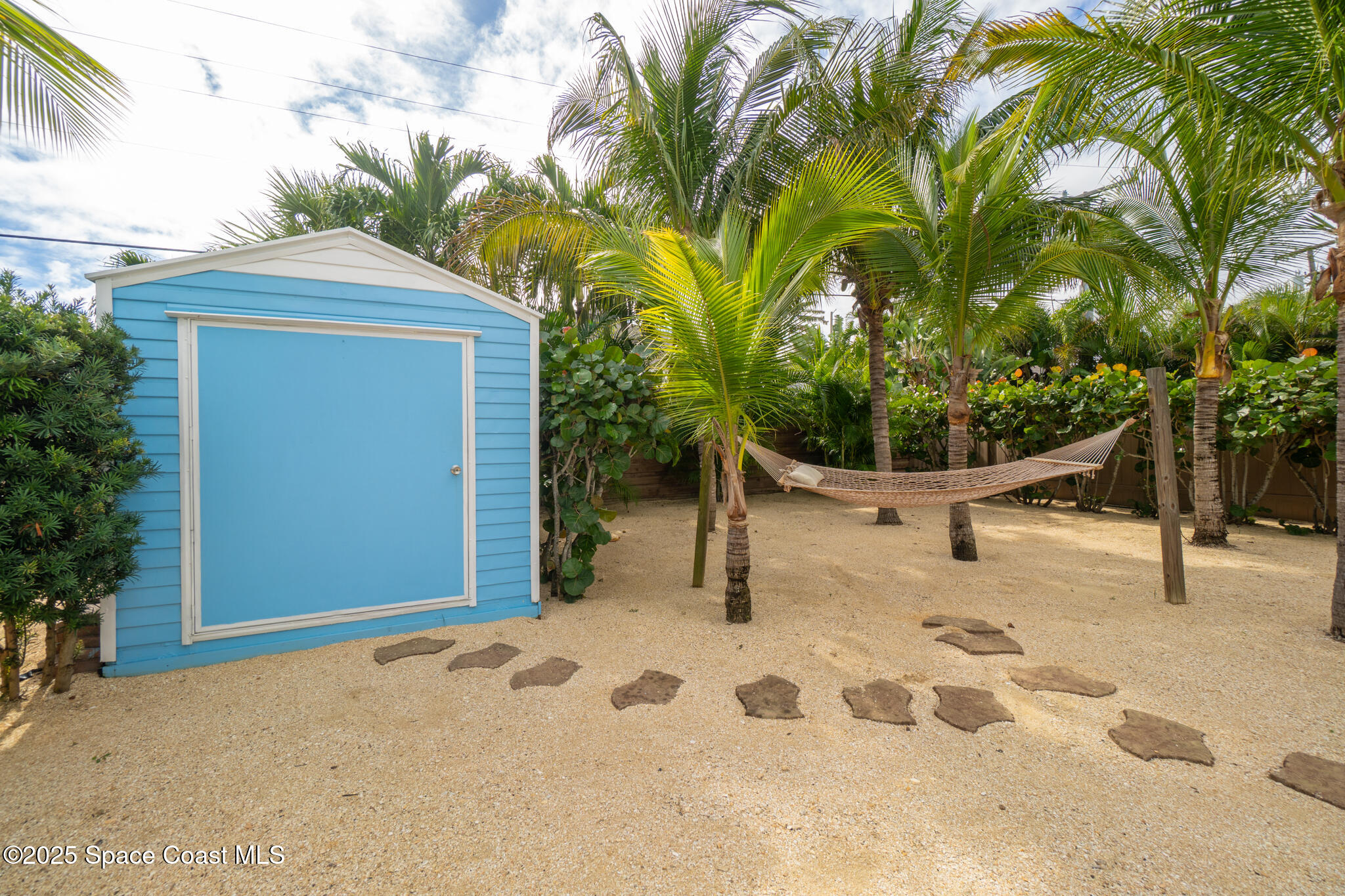 131 Harding Avenue, Unit 131 & 129 Cocoa Beach, FL 32931 - Photo 18 of 47 a view of a backyard of the house