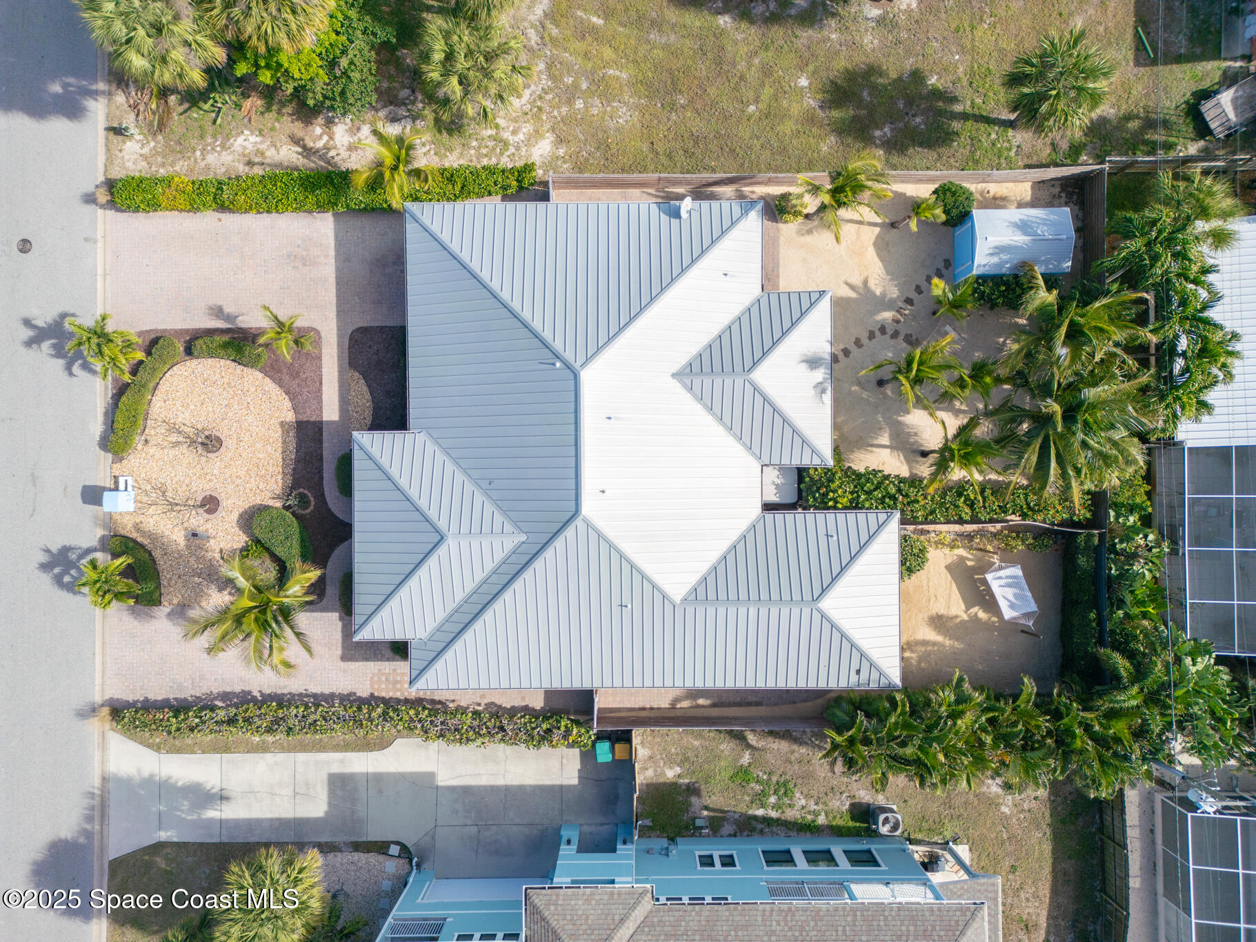 131 Harding Avenue, Unit 131 & 129 Cocoa Beach, FL 32931 - Photo 22 of 47 an aerial view of a house with a yard and large trees