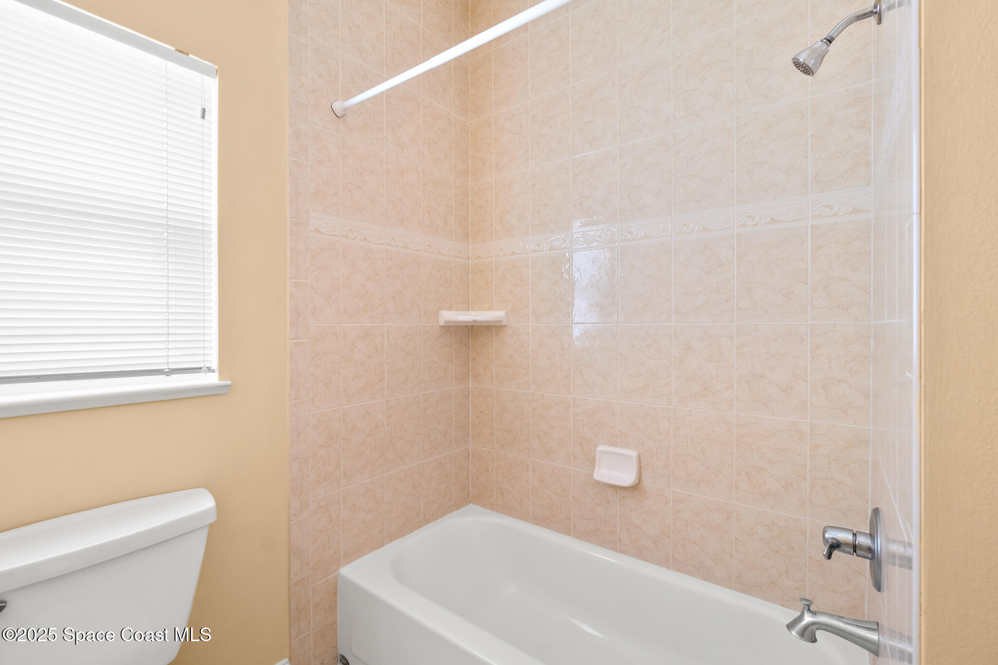 131 Harding Avenue, Unit 131 & 129 Cocoa Beach, FL 32931 - Photo 27 of 47 a bathroom with a white toilet and a shower