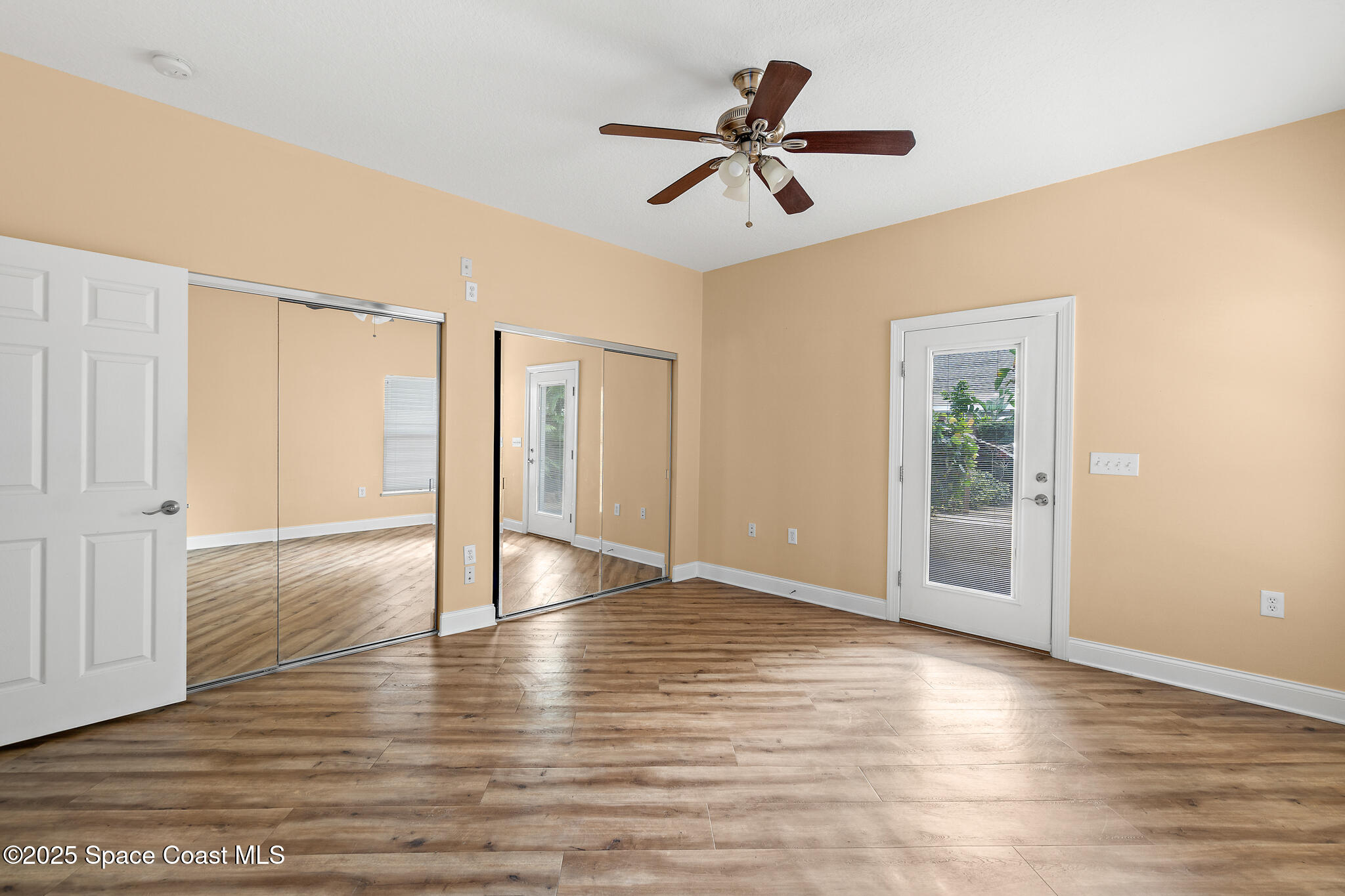 131 Harding Avenue, Unit 131 & 129 Cocoa Beach, FL 32931 - Photo 28 of 47 a view of empty room with wooden floor and ceiling fan