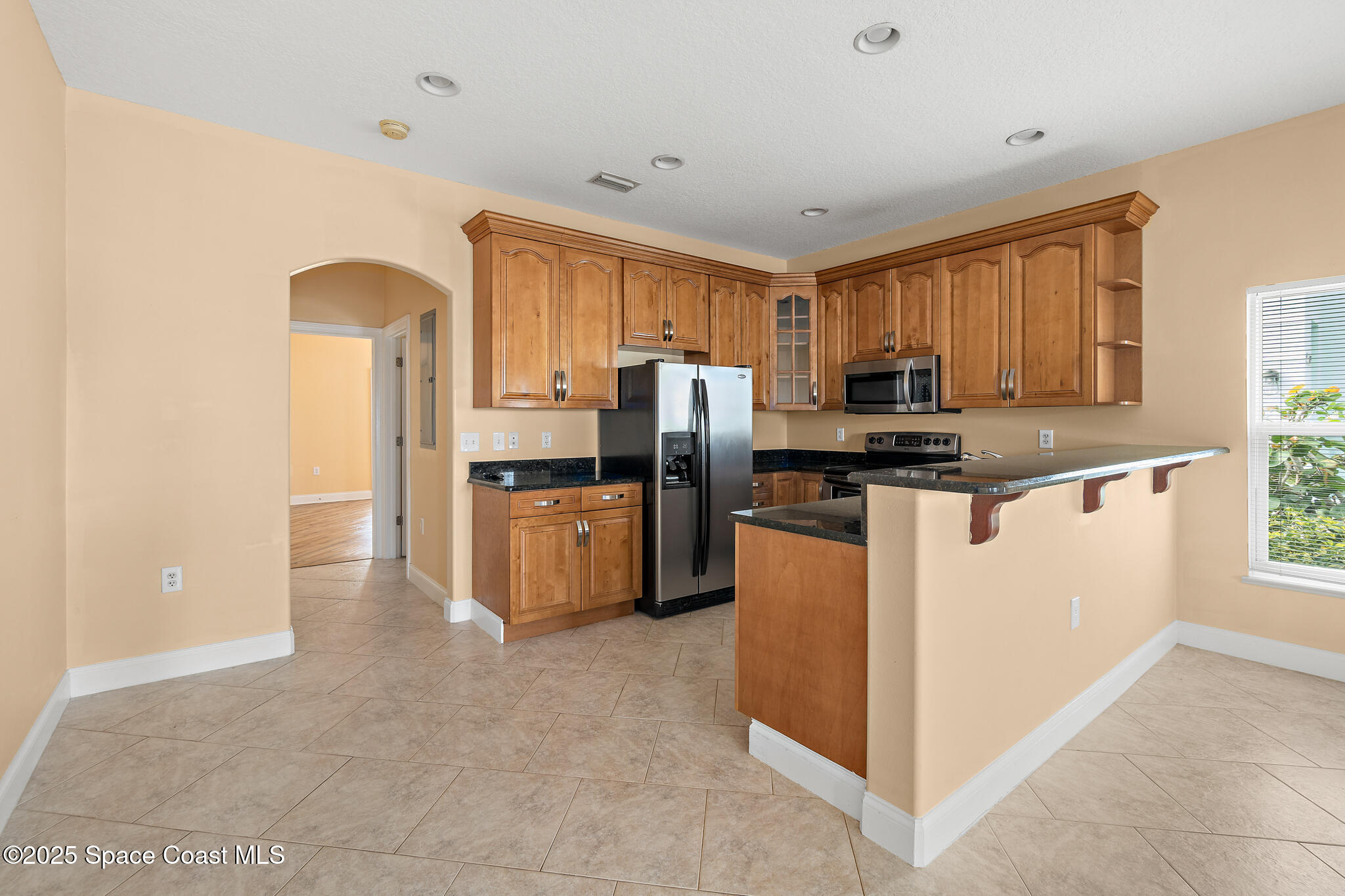131 Harding Avenue, Unit 131 & 129 Cocoa Beach, FL 32931 - Photo 29 of 47 a kitchen with stainless steel appliances a refrigerator sink and microwave