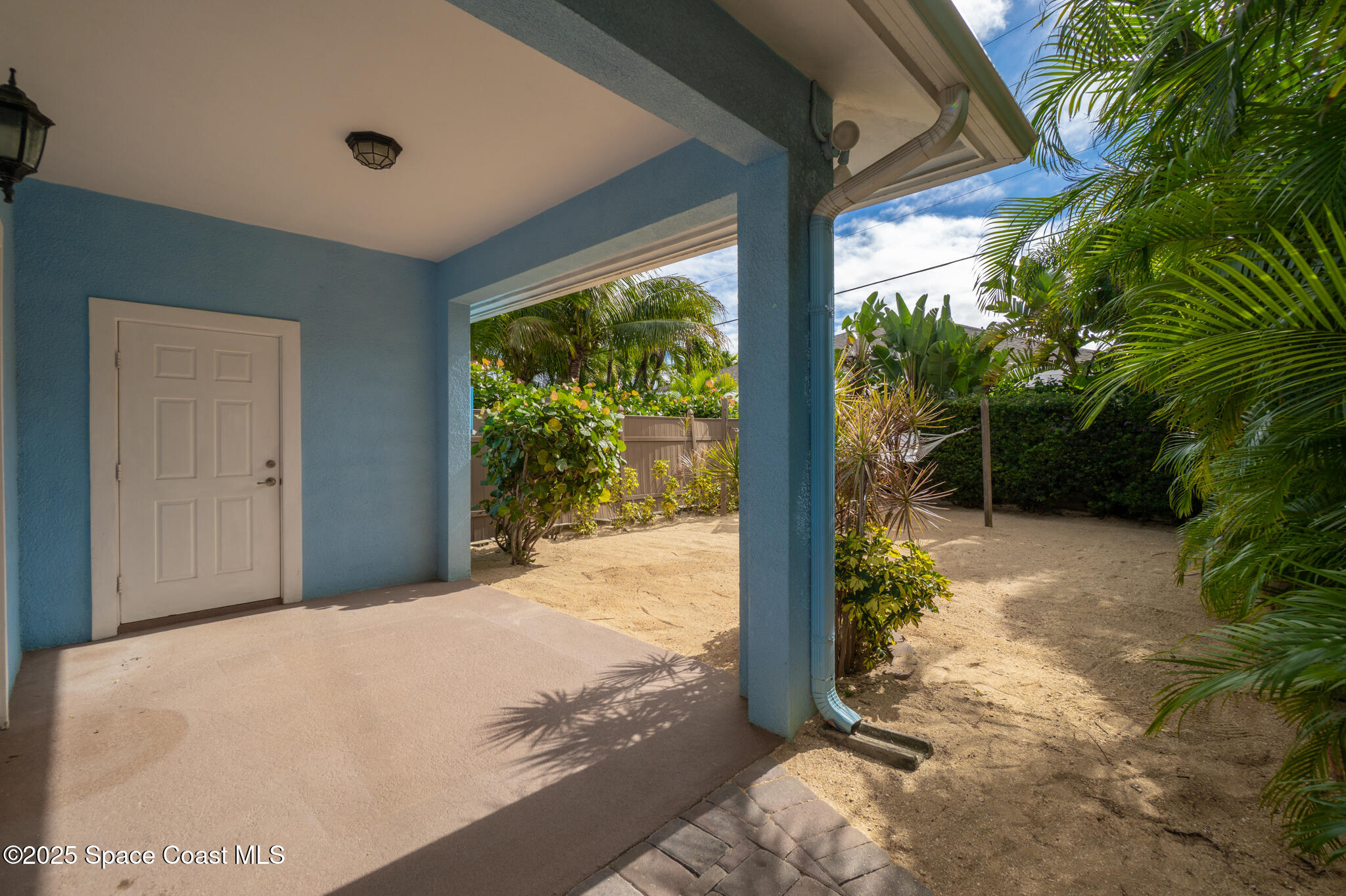 131 Harding Avenue, Unit 131 & 129 Cocoa Beach, FL 32931 - Photo 32 of 47 a bedroom with a bed and a large window