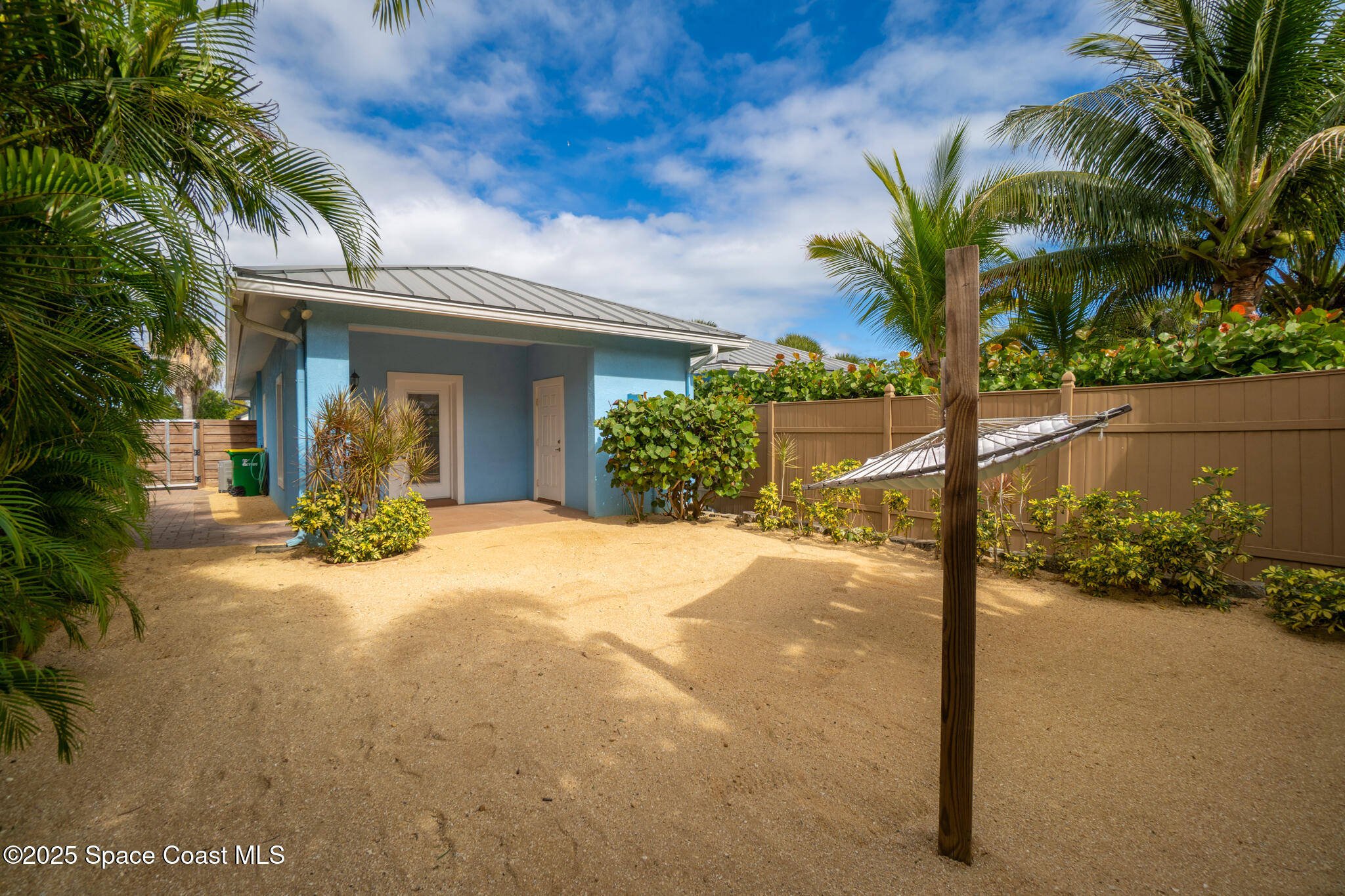 131 Harding Avenue, Unit 131 & 129 Cocoa Beach, FL 32931 - Photo 33 of 47 a view of a house with a yard