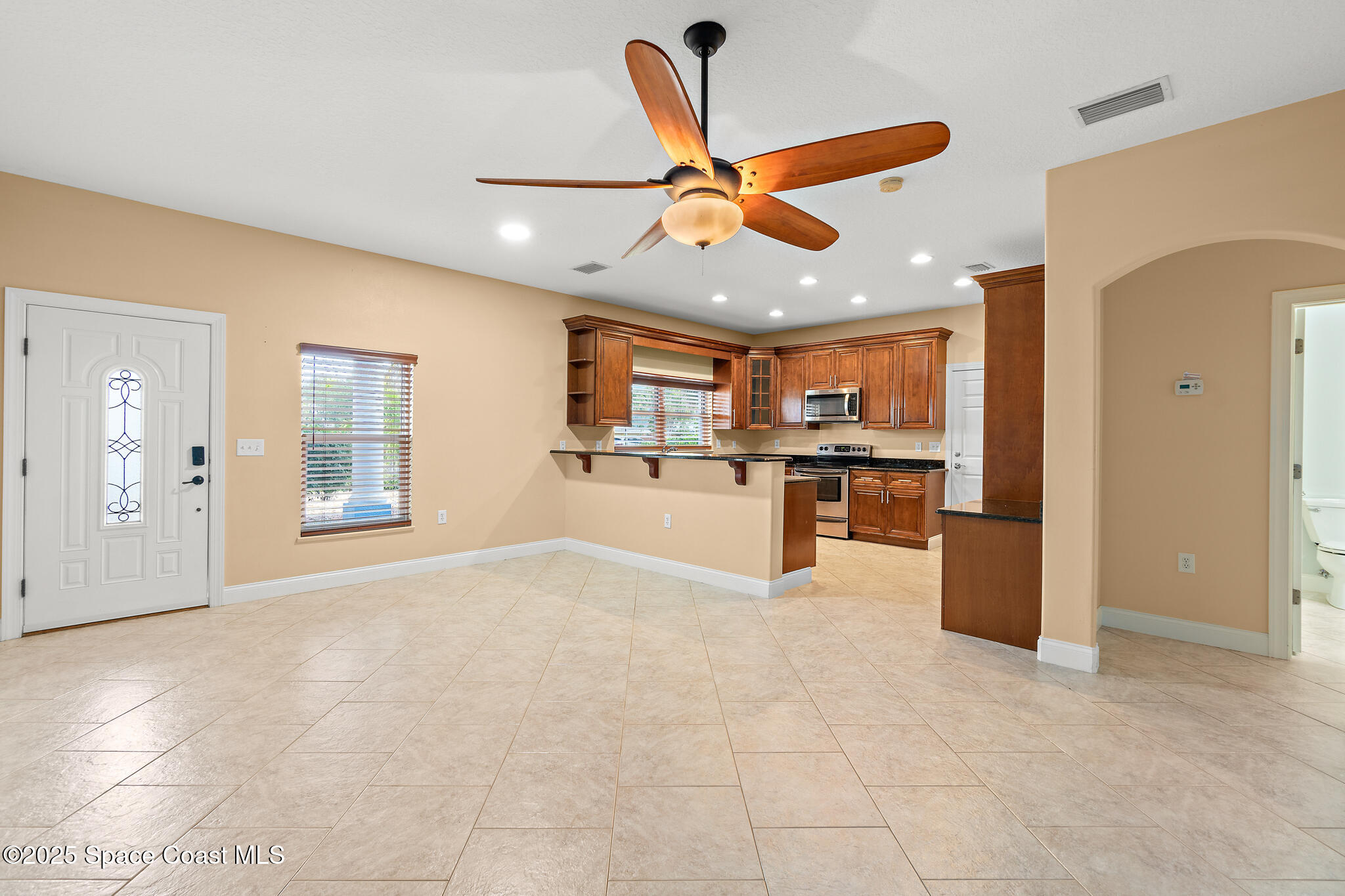 131 Harding Avenue, Unit 131 & 129 Cocoa Beach, FL 32931 - Photo 4 of 47 a view of a kitchen with a refrigerator and a sink