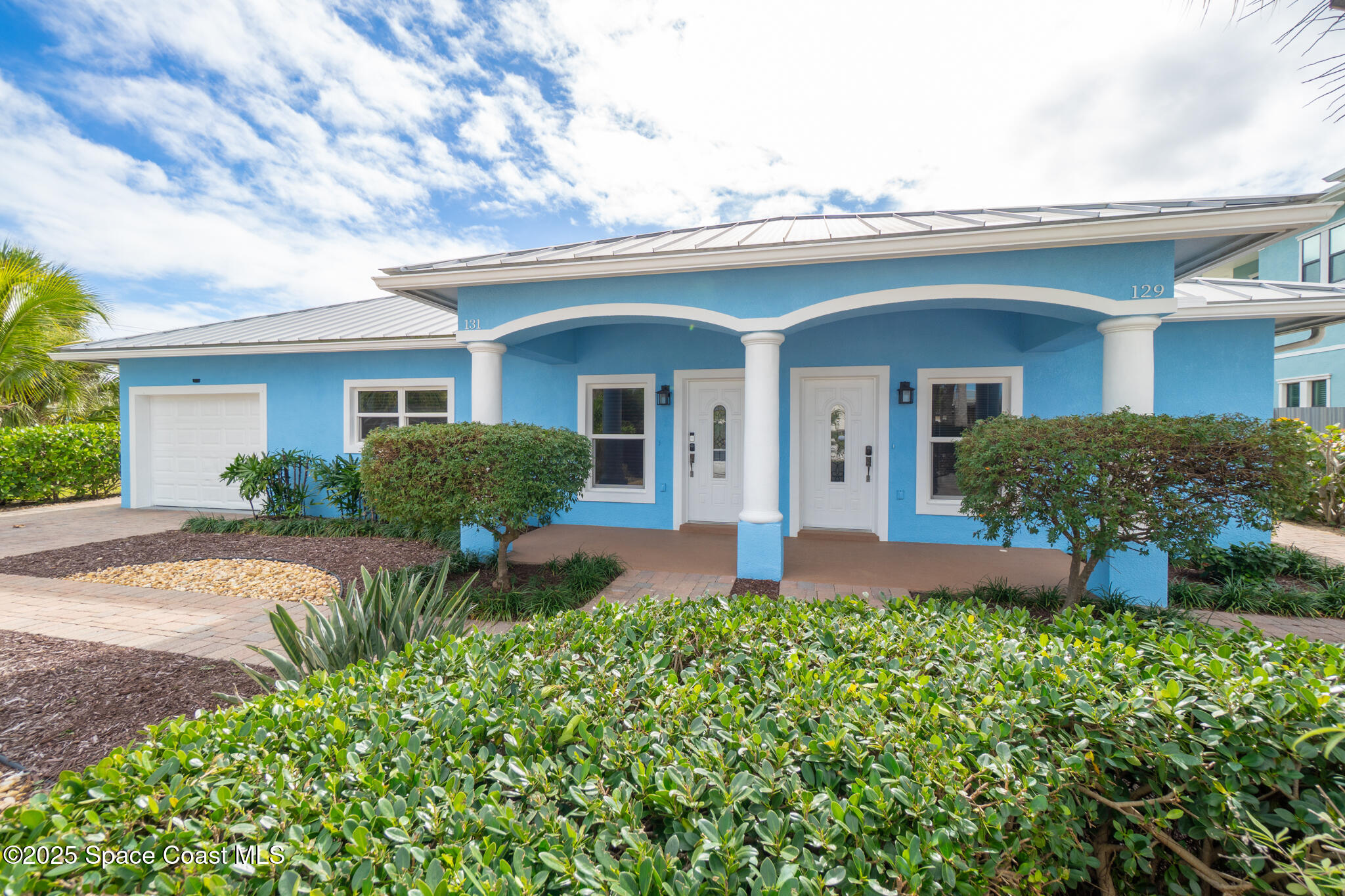 131 Harding Avenue, Unit 131 & 129 Cocoa Beach, FL 32931 - Photo 44 of 47 front view of a house with a yard